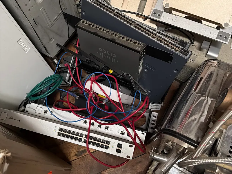 Old network switches and cables piled in a storage room