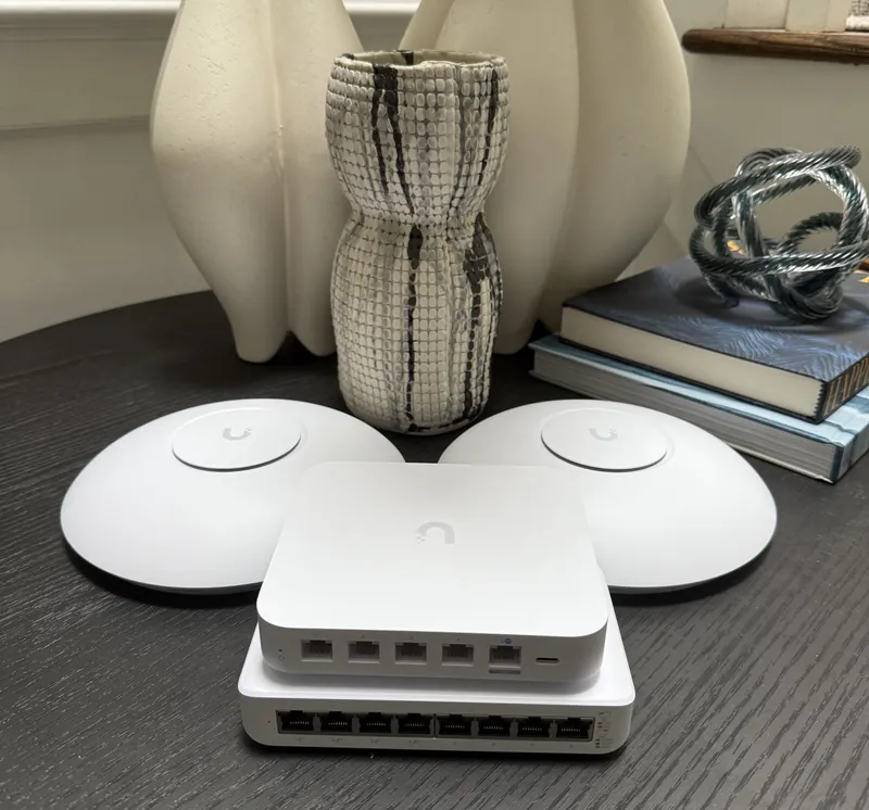 UniFi gateway stacked on a small switch, ports facing forward