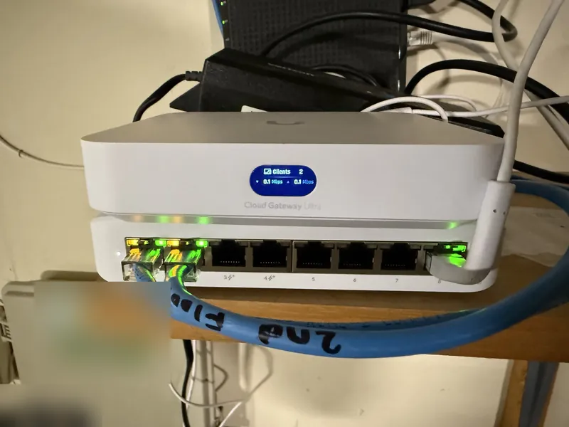 UniFi Cloud Gateway Ultra on a shelf with a blue cable labeled 2nd Floor