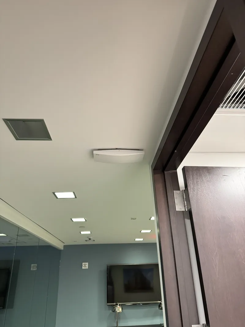 Wi-Fi access point on an office ceiling near a doorway